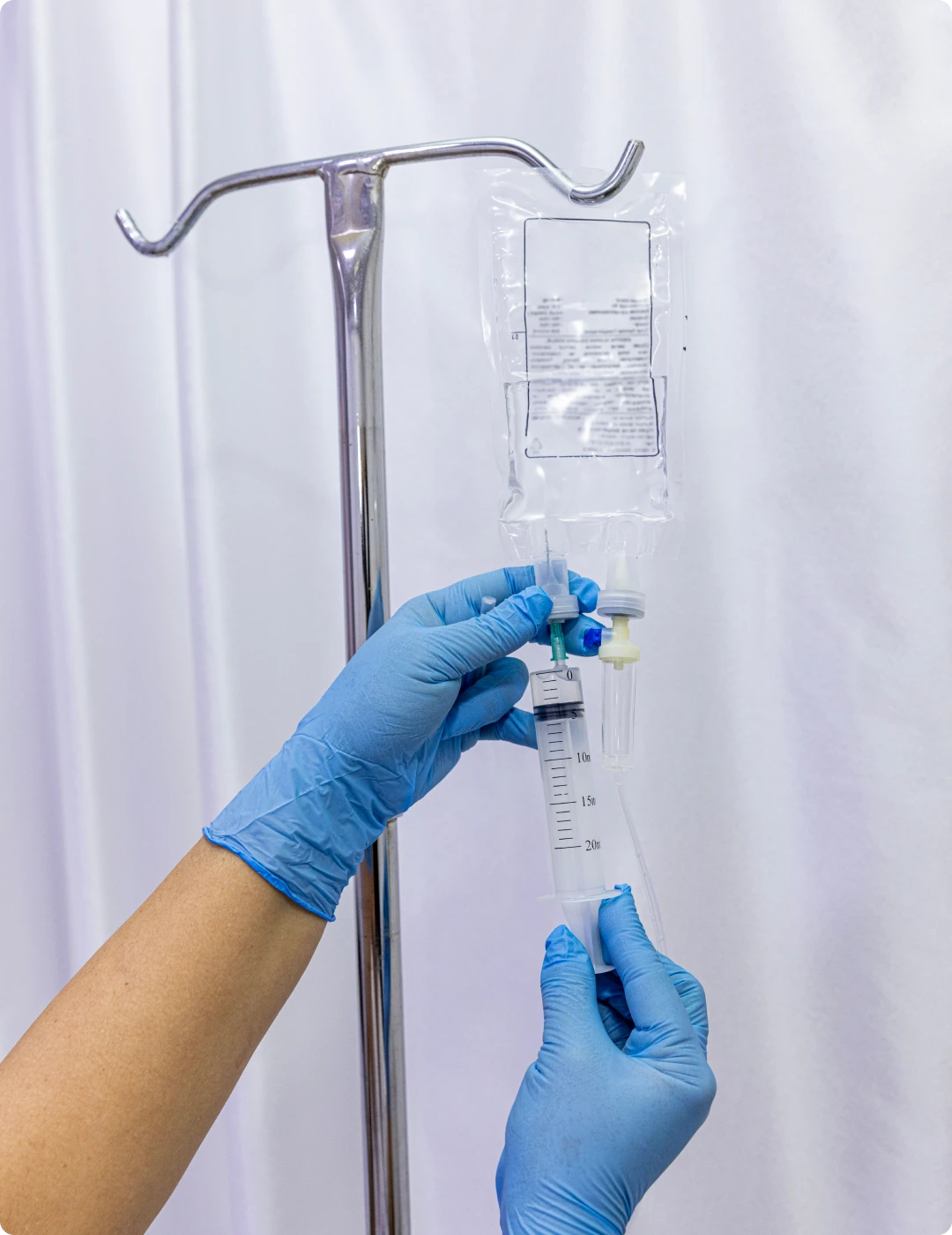 Medical professional preparing IV drip