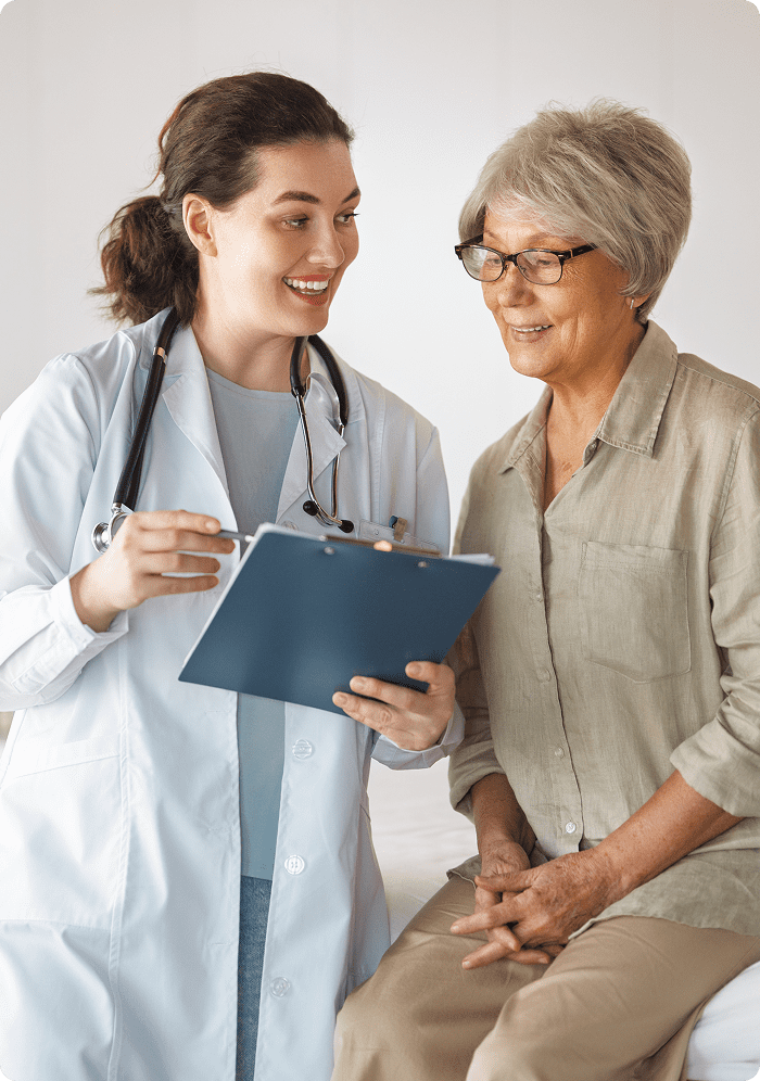 Healthcare professional discussing with senior woman