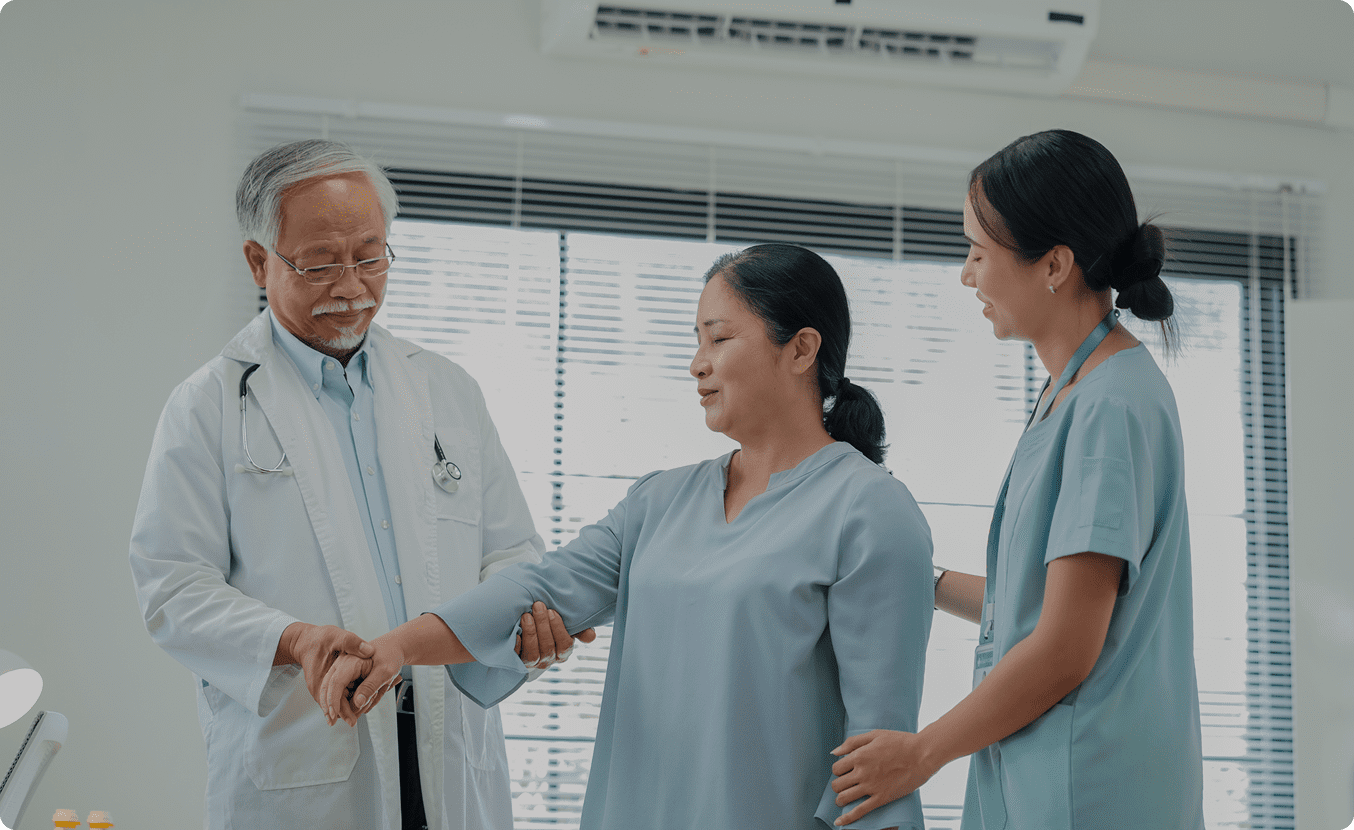 Healthcare professionals assisting patient in clinic.