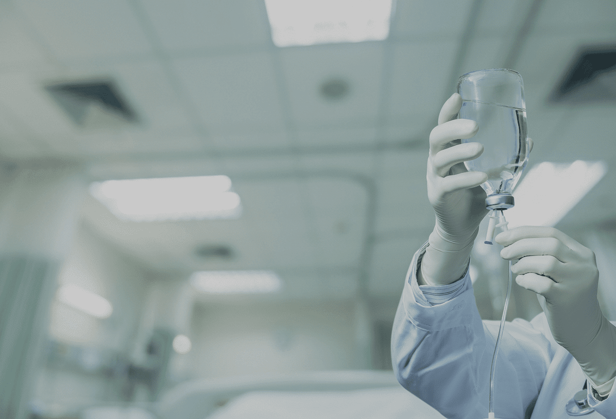 Nurse adjusting intravenous fluid bag